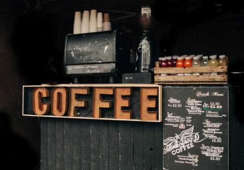 brown coffee signage beside poster