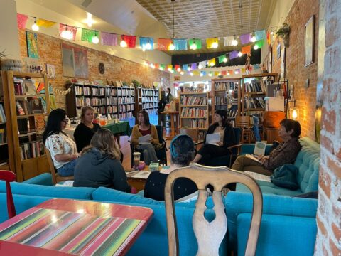 A group of people sitting at tables in a library